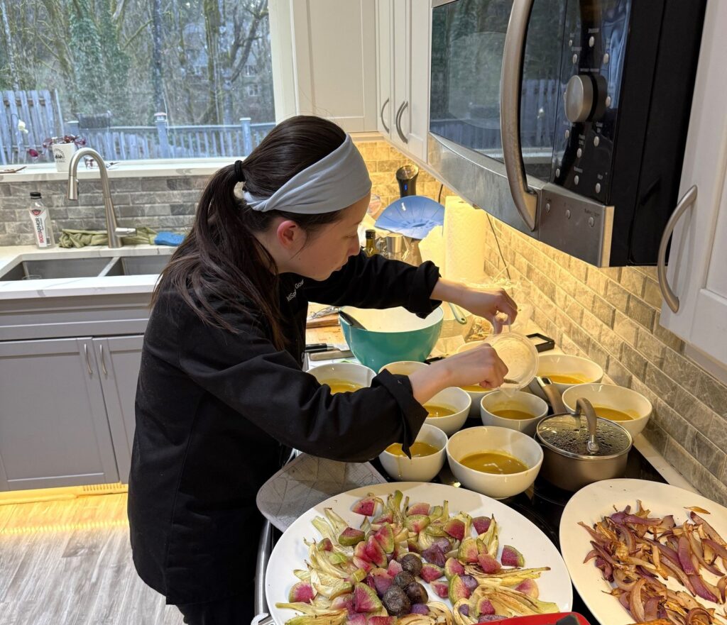 chef mia in kitchen plating butternut bisque