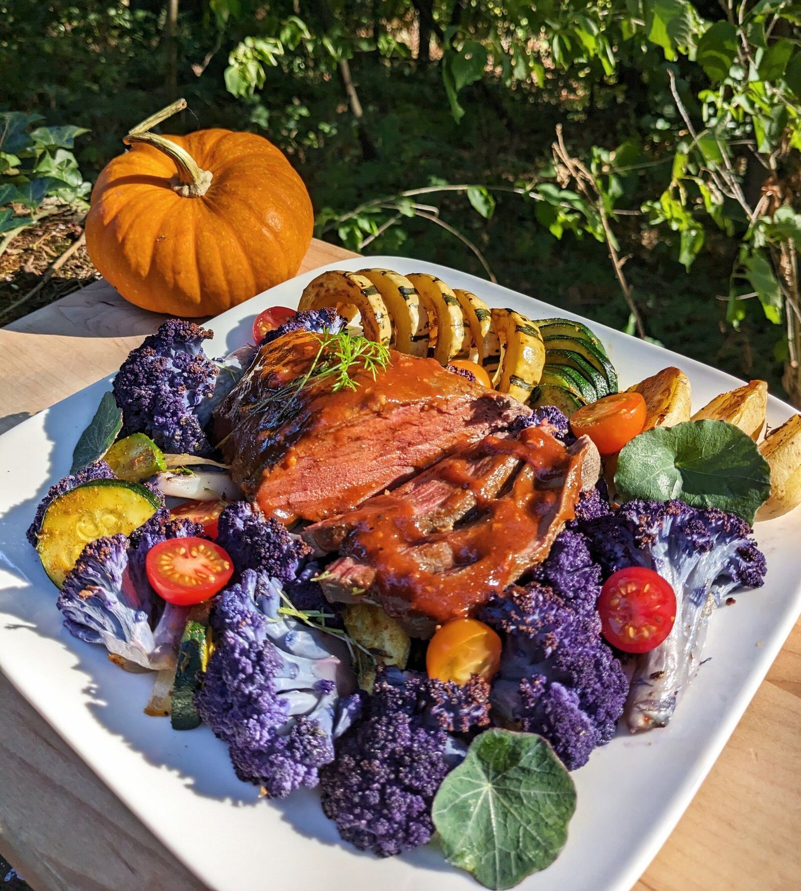 fall harvest beef roast with purple cauliflower, squash, cherry tomato, baby potato